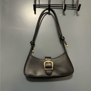 Black shoulder bag with gold buckle detail